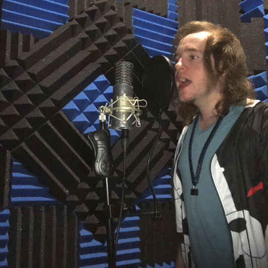 Man Singing In A Vocal Booth Treated With Acoustic Foam Panels