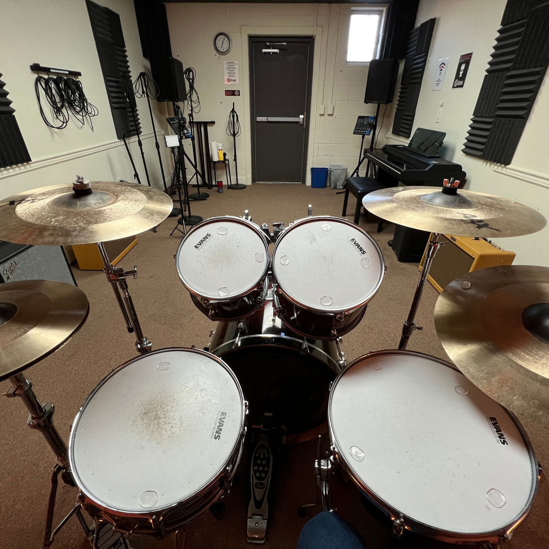drum room with acoustic treatment including acoustic foam panels and bass traps